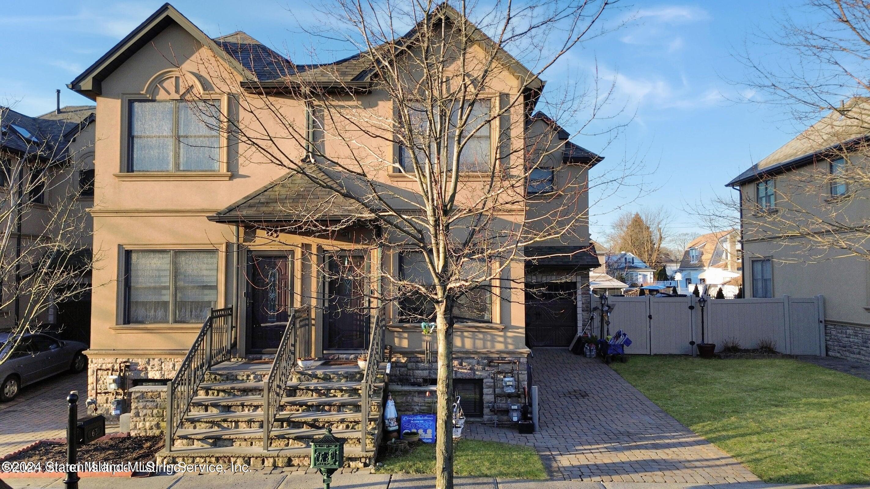 a front view of house with a garden