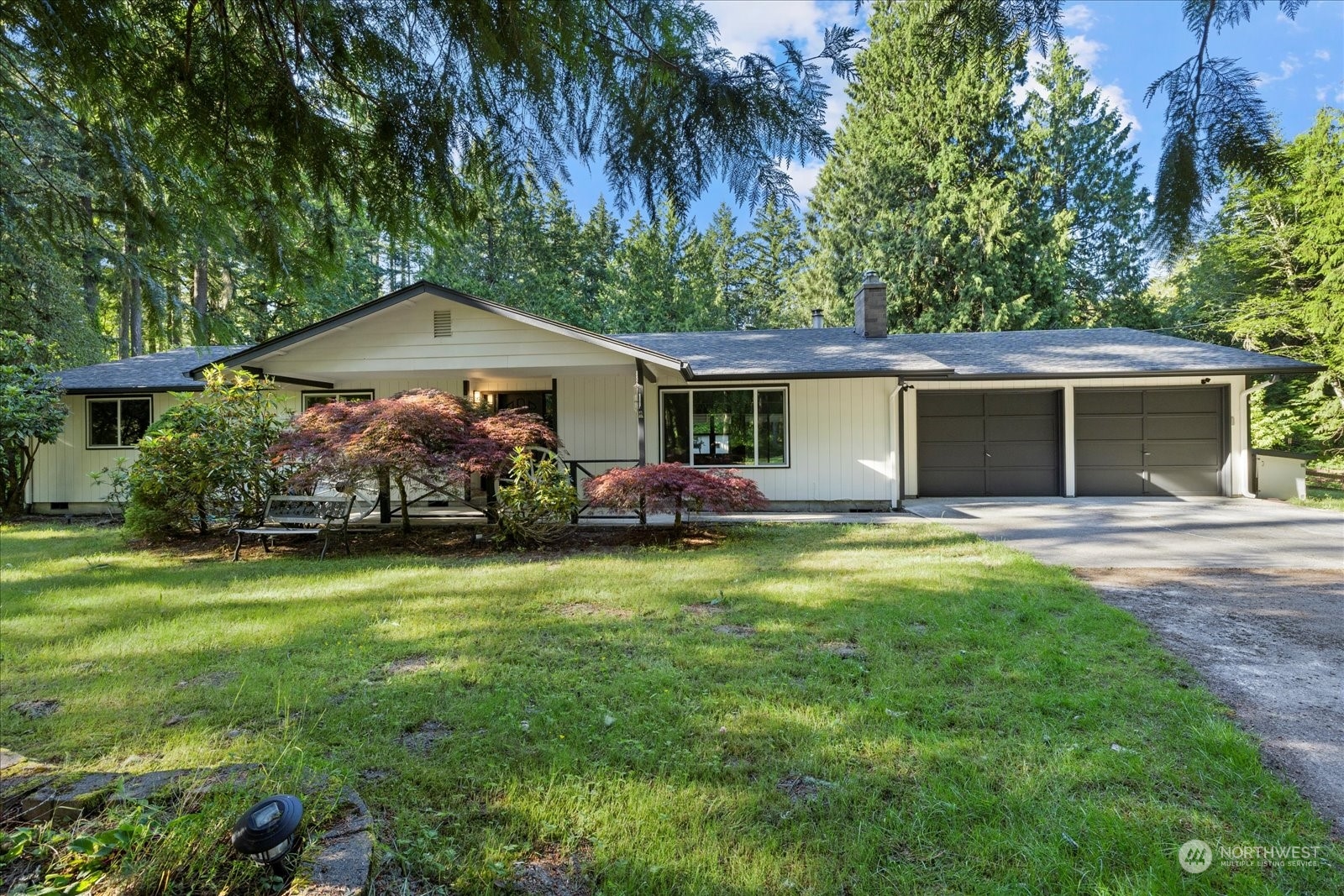 a front view of a house with a garden