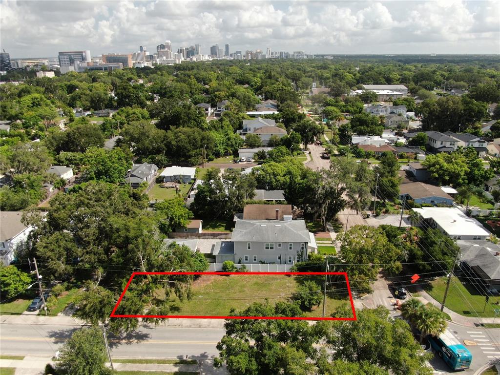 an aerial view of residential house with outdoor space and trees all around