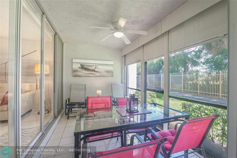 a view of a dining room with furniture large windows and wooden floor