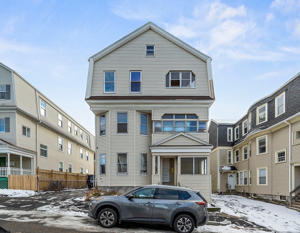 a front view of a residential apartment building with a yard