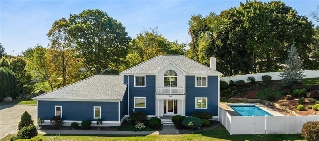 a front view of a house with a yard garage and outdoor seating