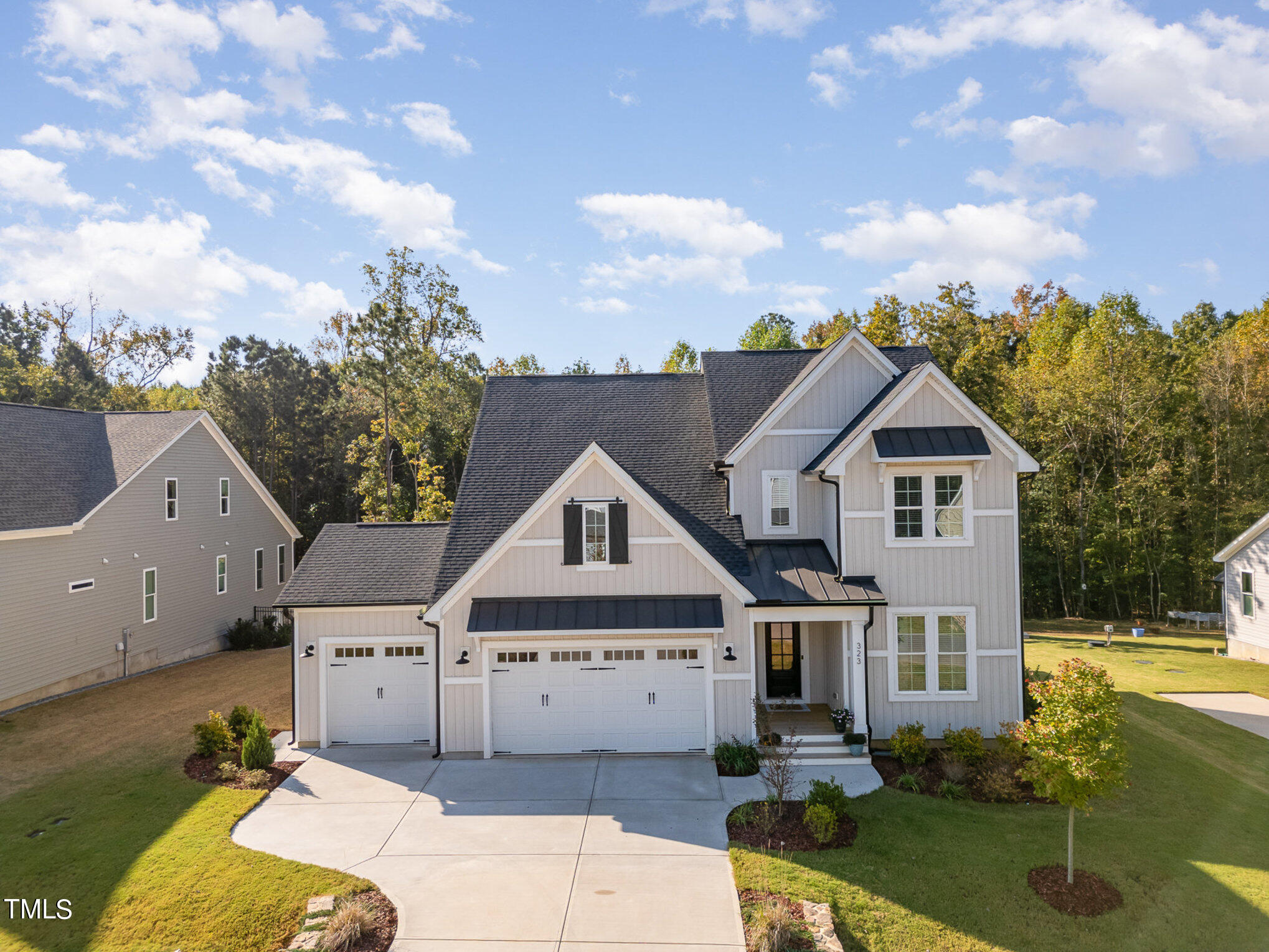 a aerial view of a house next to a yard