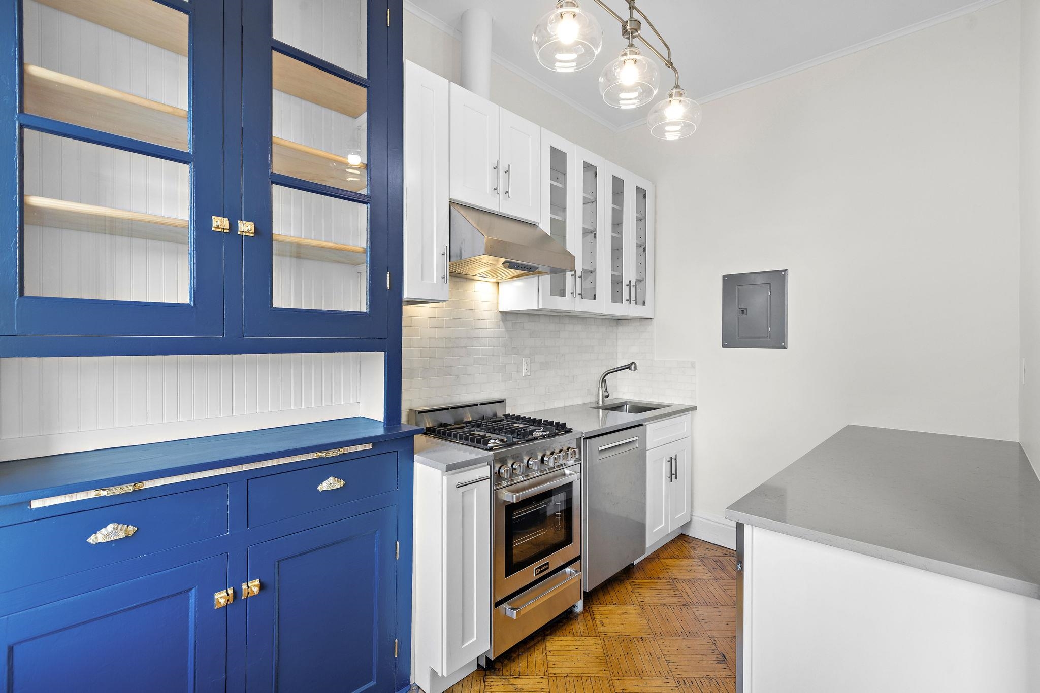 a kitchen with stainless steel appliances granite countertop a stove and a sink