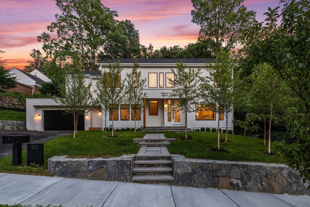 a front view of a house with a garden