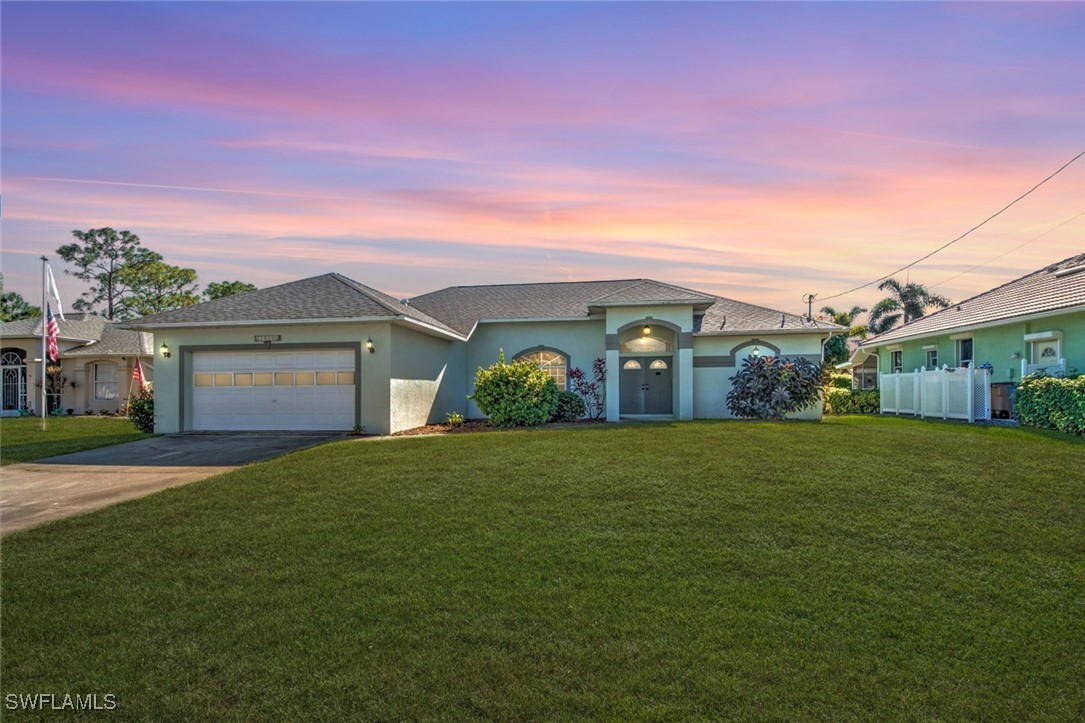 a front view of a house with a yard and garage