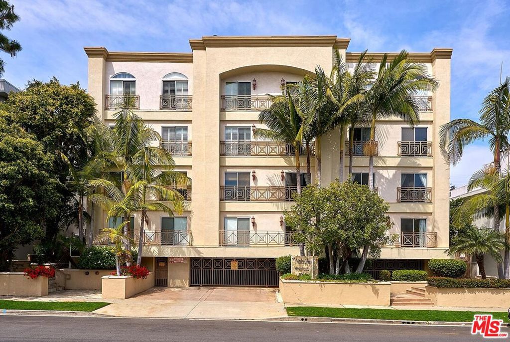 a front view of a multi story residential apartment building with a yard