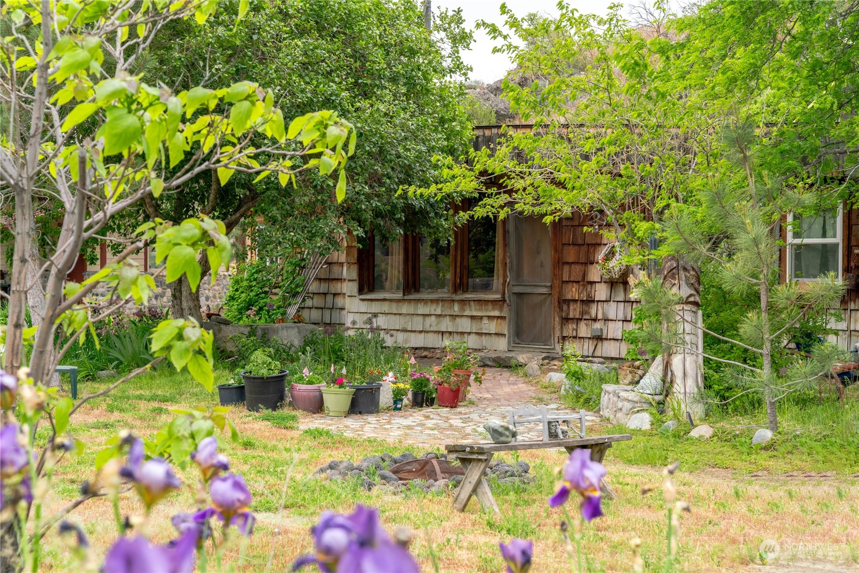 a front view of a house with a tree