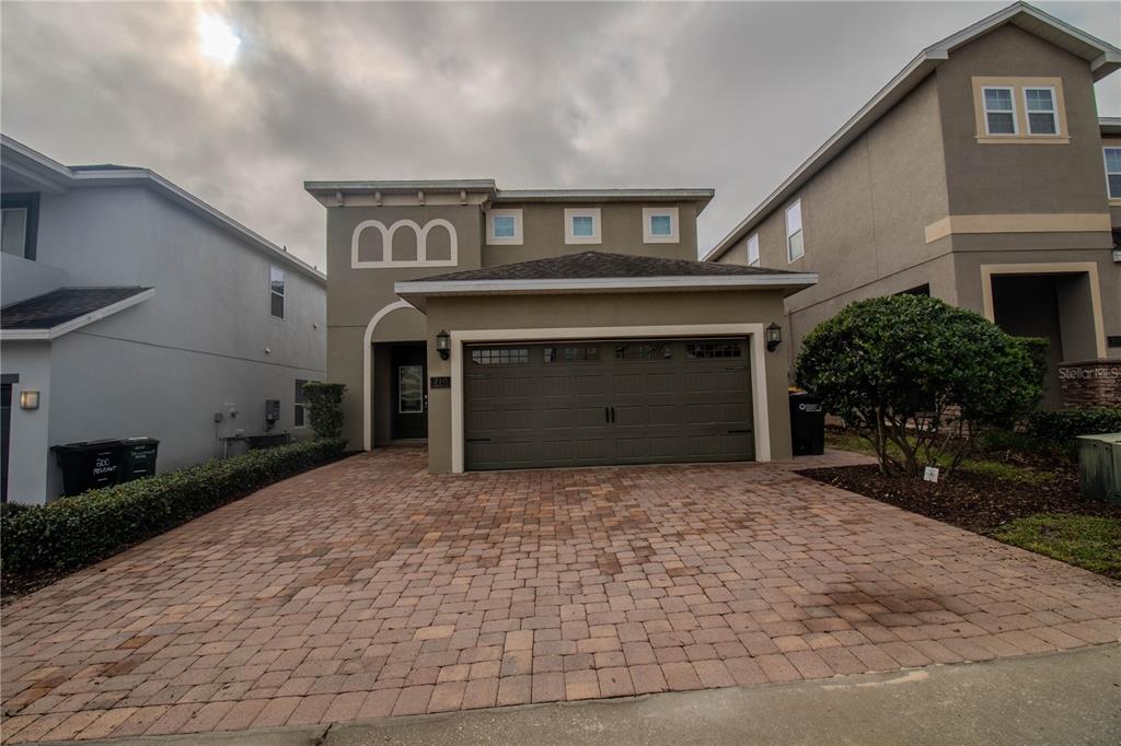 a front view of a house with a yard and garage