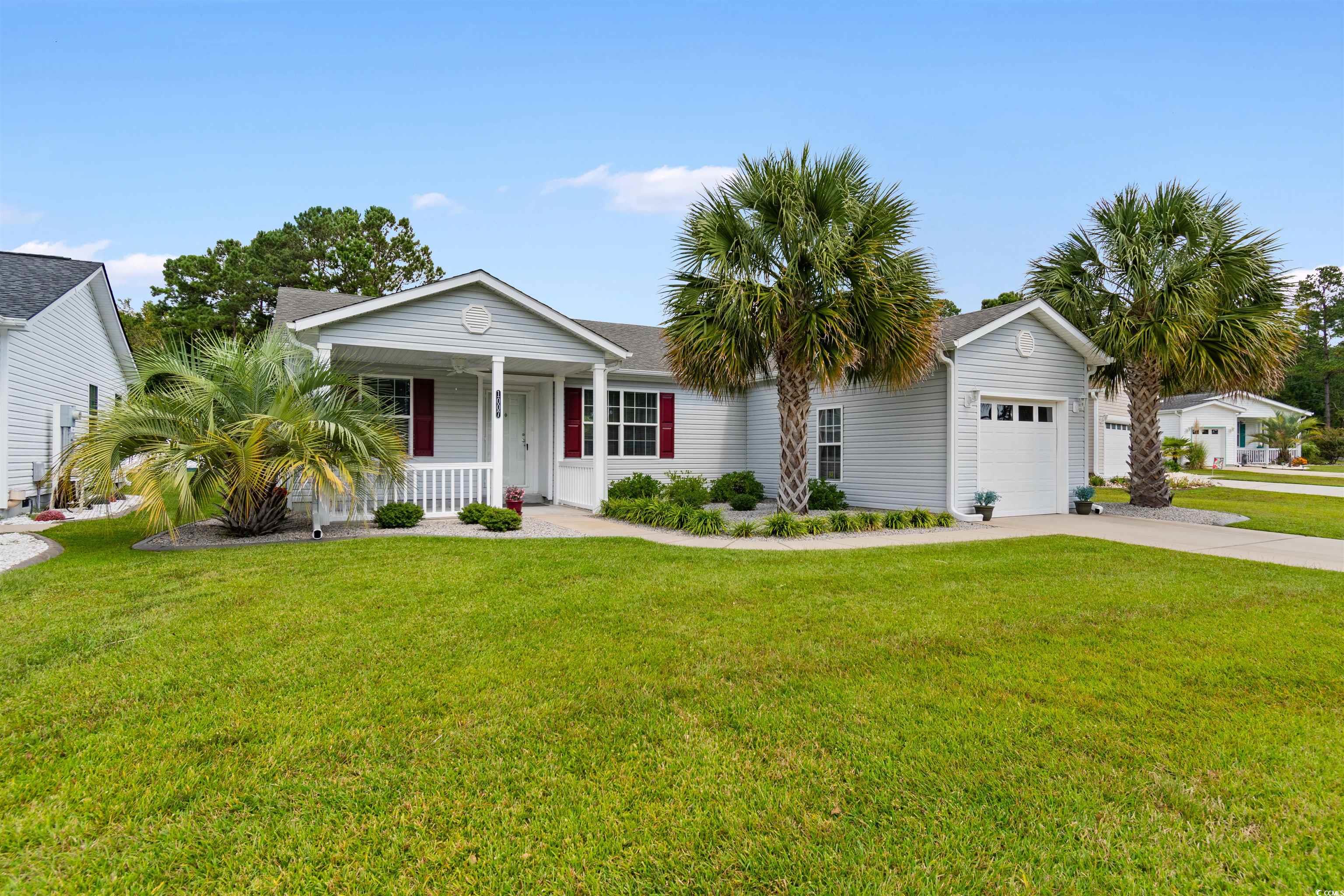 Ranch-style house with a garage, a front lawn, and