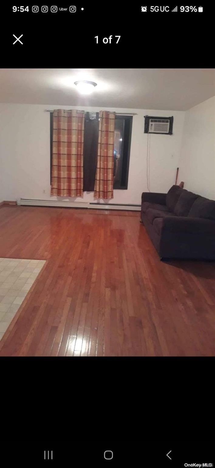 a view of an empty room and with kitchen