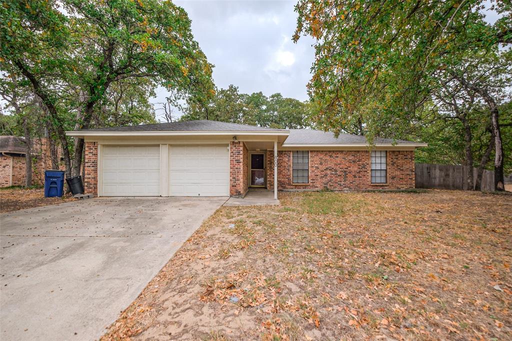 front view of a house with a yard and a garage