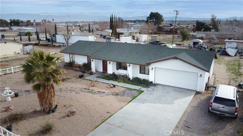 a aerial view of a house with a garden and houses