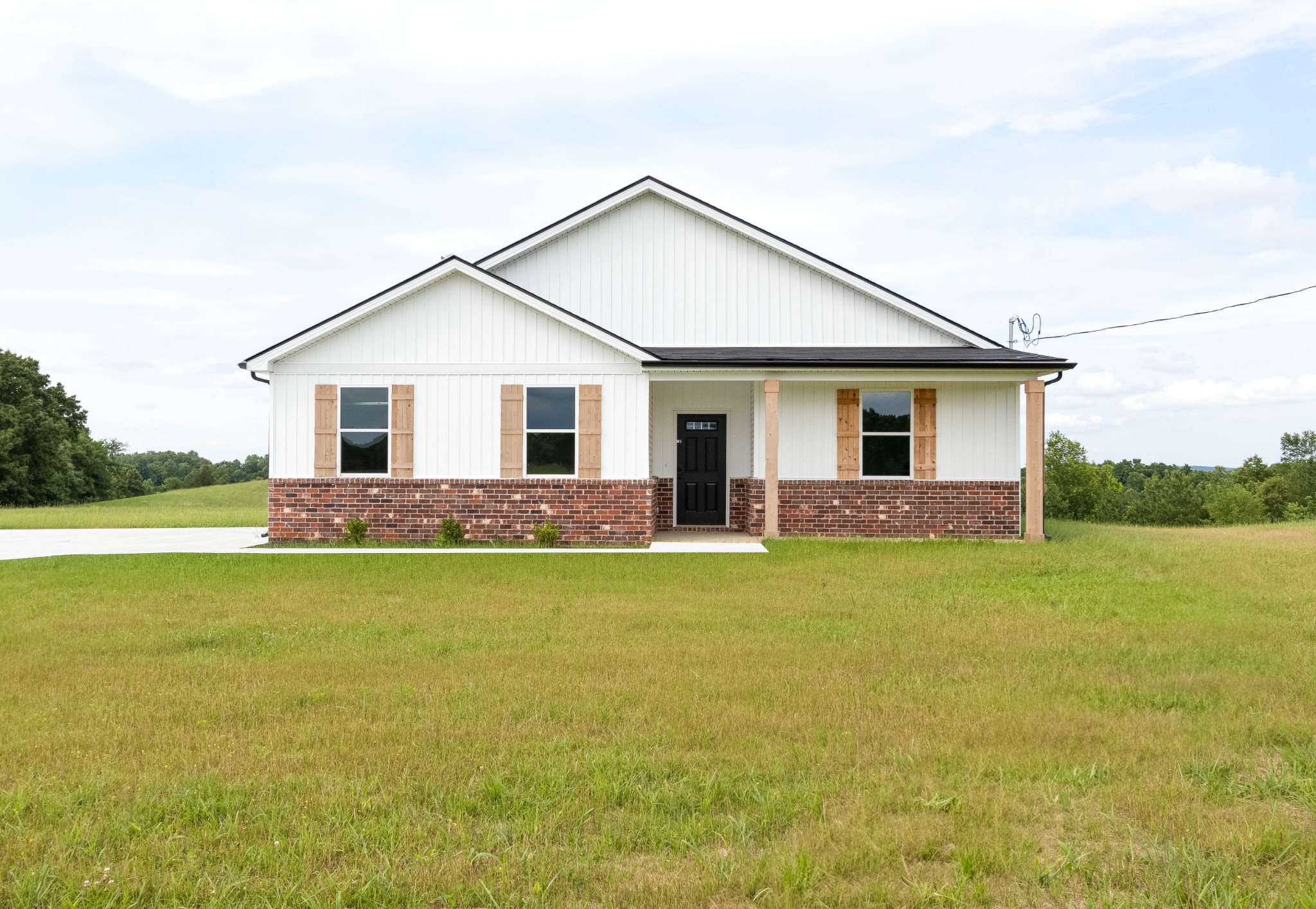 a front view of house with yard and lake view