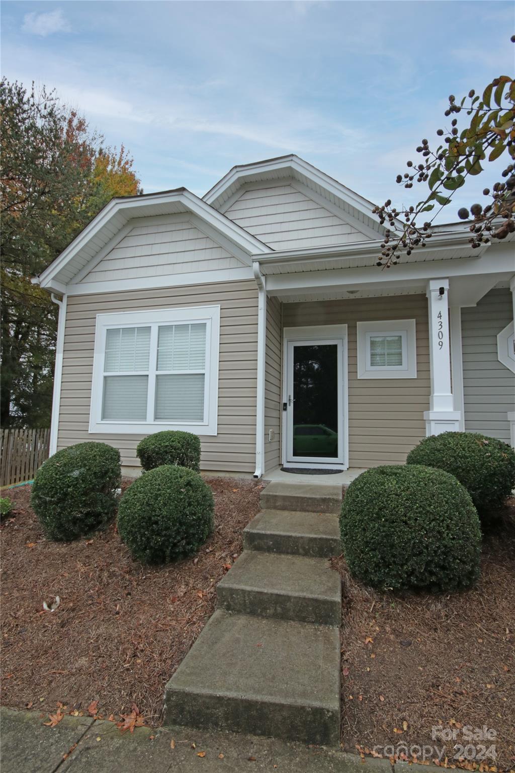 a view of a house with a small yard and plants