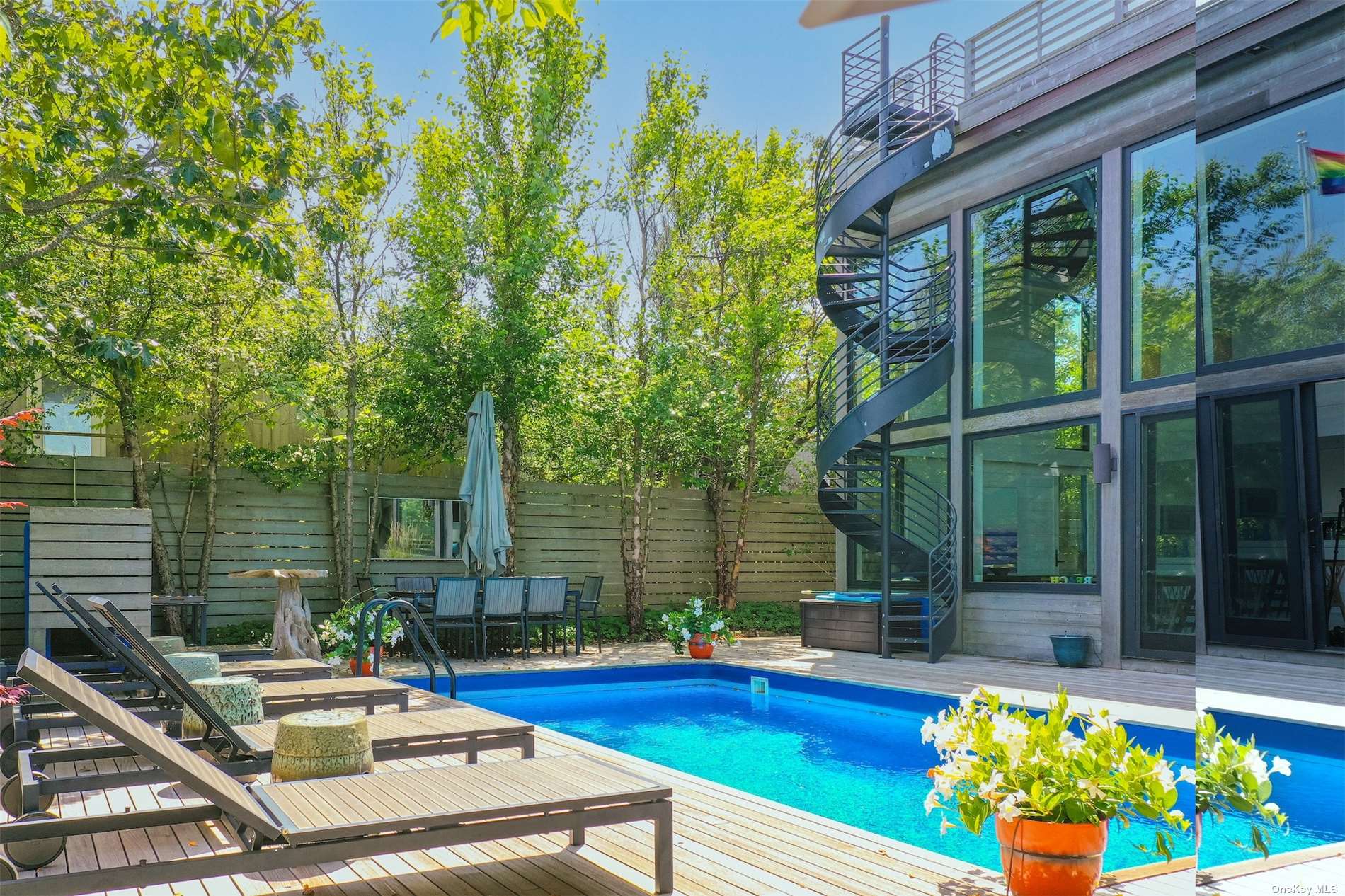 a view of swimming pool with seating area and garden