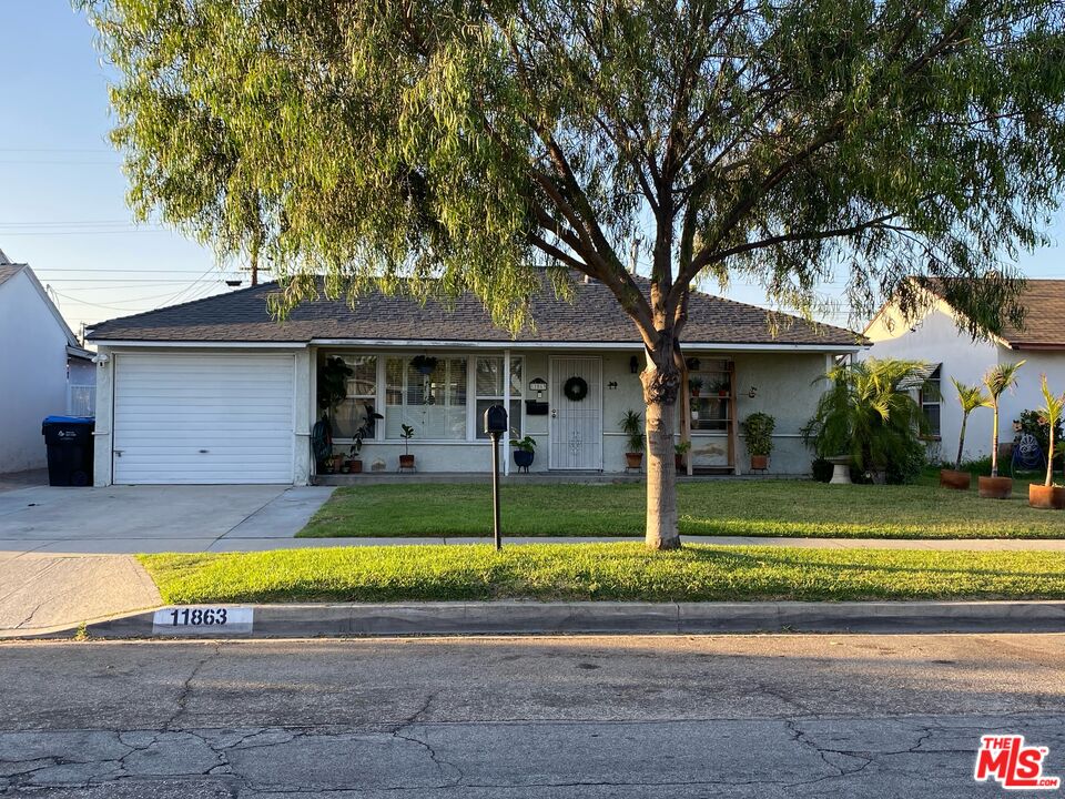 a view of a house with swimming pool and a yard