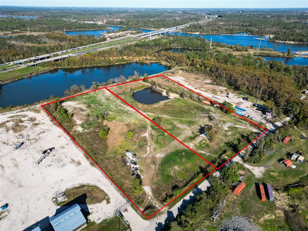 an aerial view of lake and residential houses with outdoor space