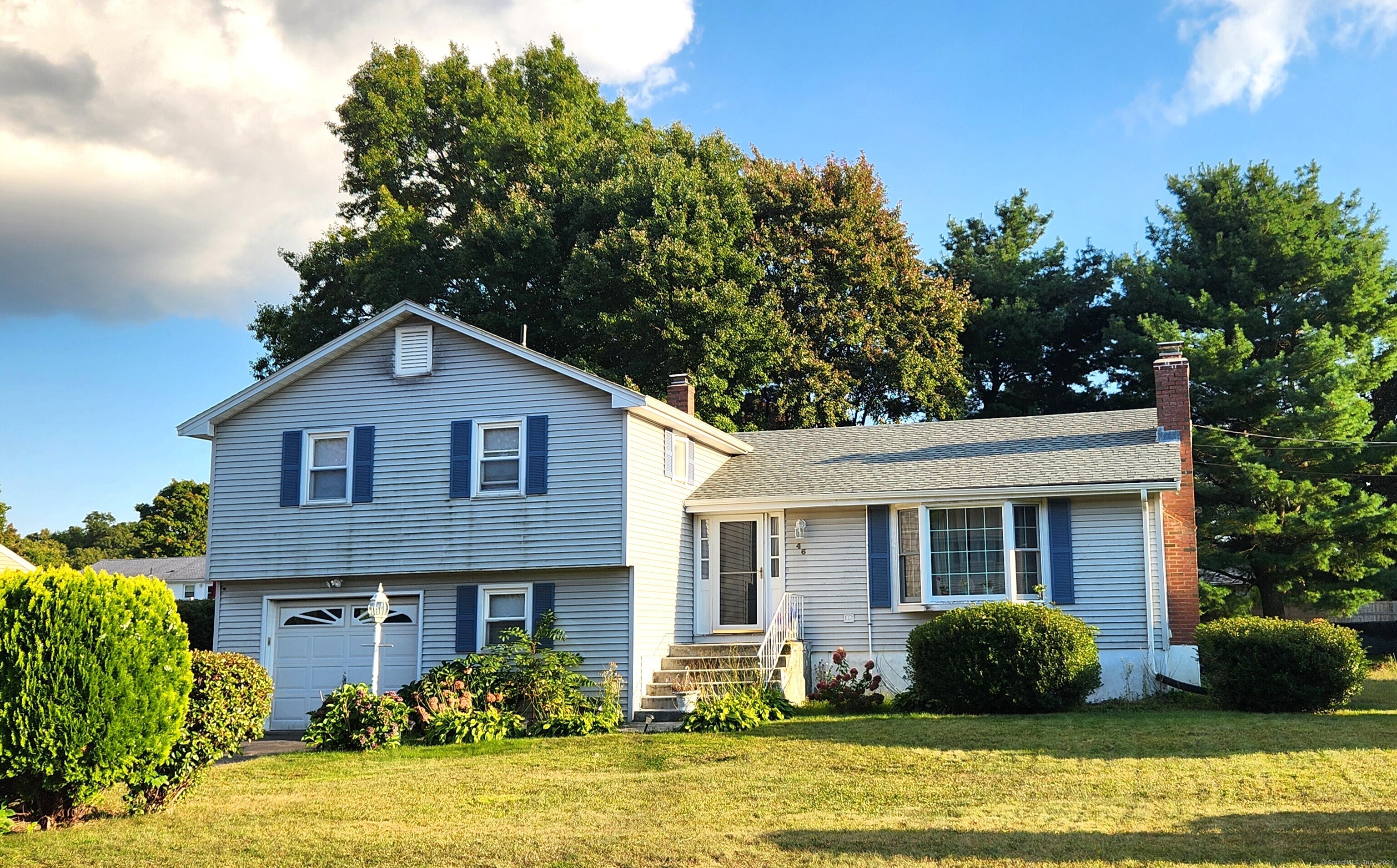 a front view of a house with garden