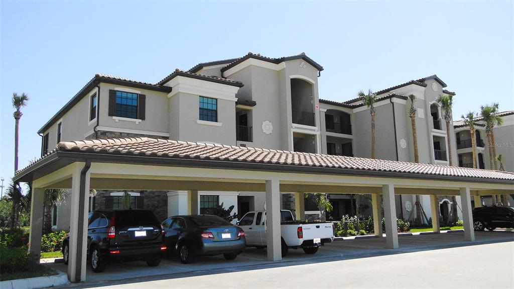 a view of a building with car parked