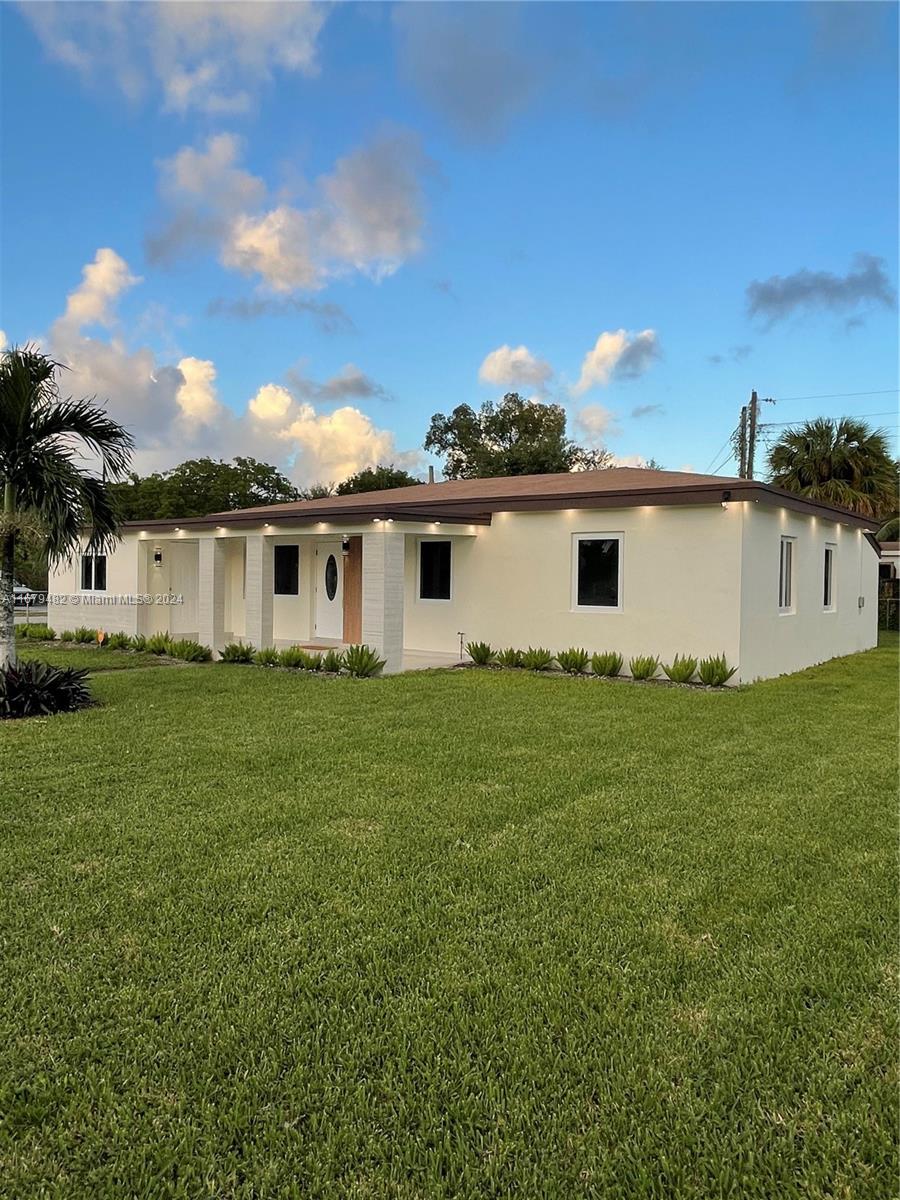 a view of a house with a backyard