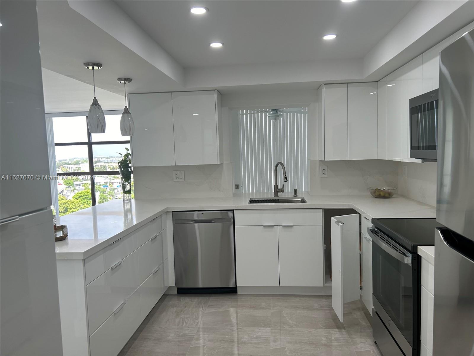 a kitchen that has a sink and a stove in it