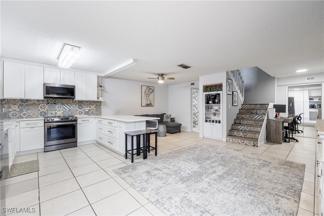 a kitchen with stainless steel appliances a stove sink and cabinets