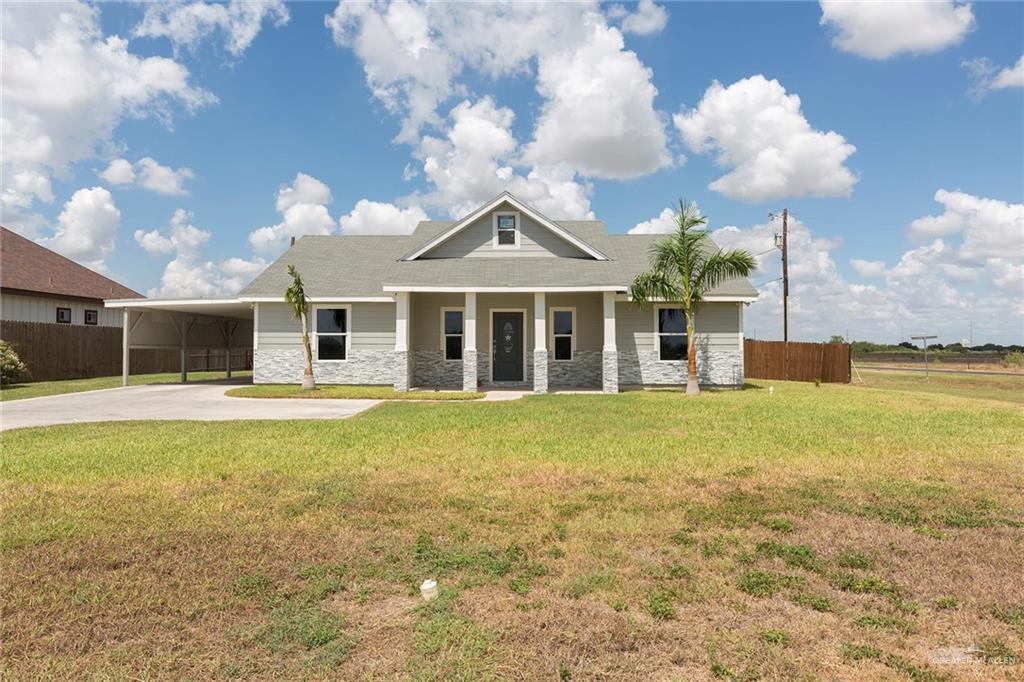 A charming stucco and stone home with a warm, inviting exterior  -features arched windows and a rustic wooden door.  The front porch adds country charm and the interior bathes you in modern luxury.