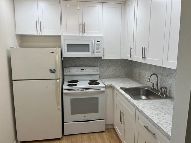 a kitchen with cabinets appliances and a sink