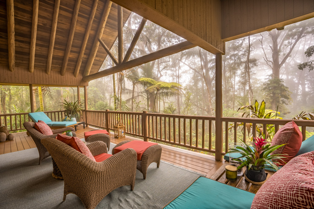 a view of a porch with furniture and wooden floor