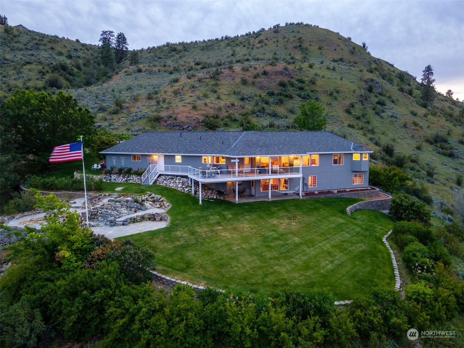 an aerial view of a house with a big yard