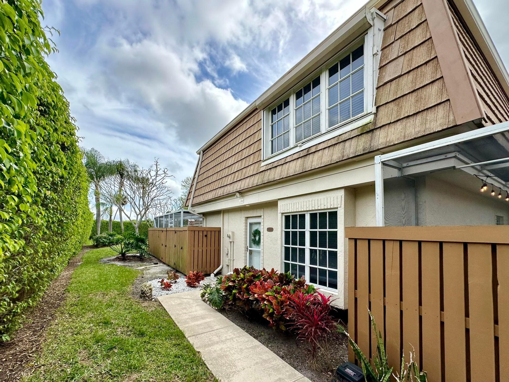 a front view of a house with a garden