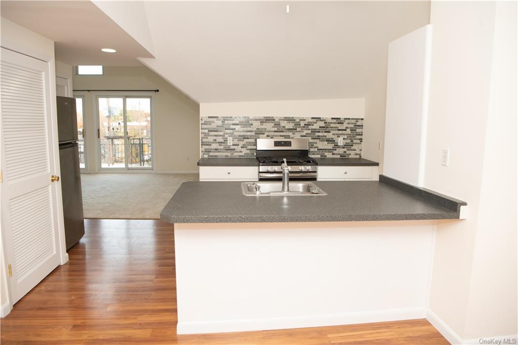 a view of a kitchen with a sink and microwave