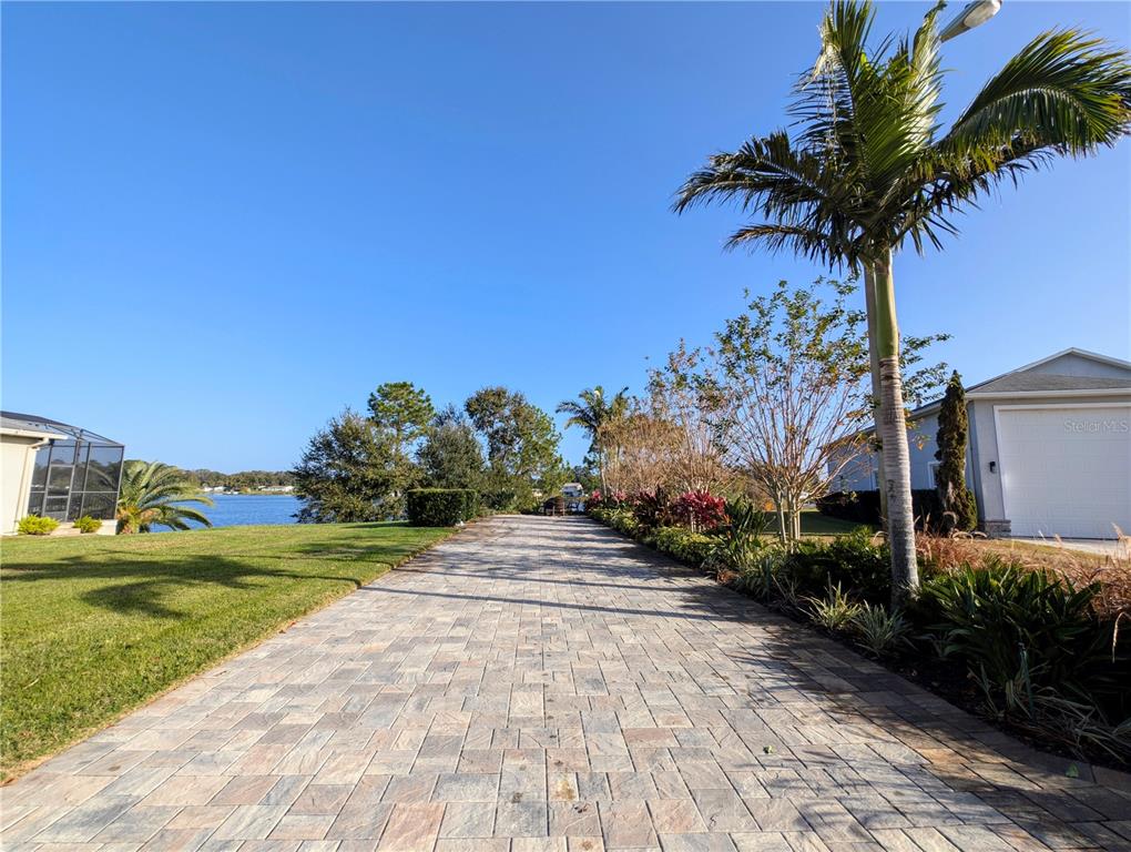 a pathway of a house with a yard