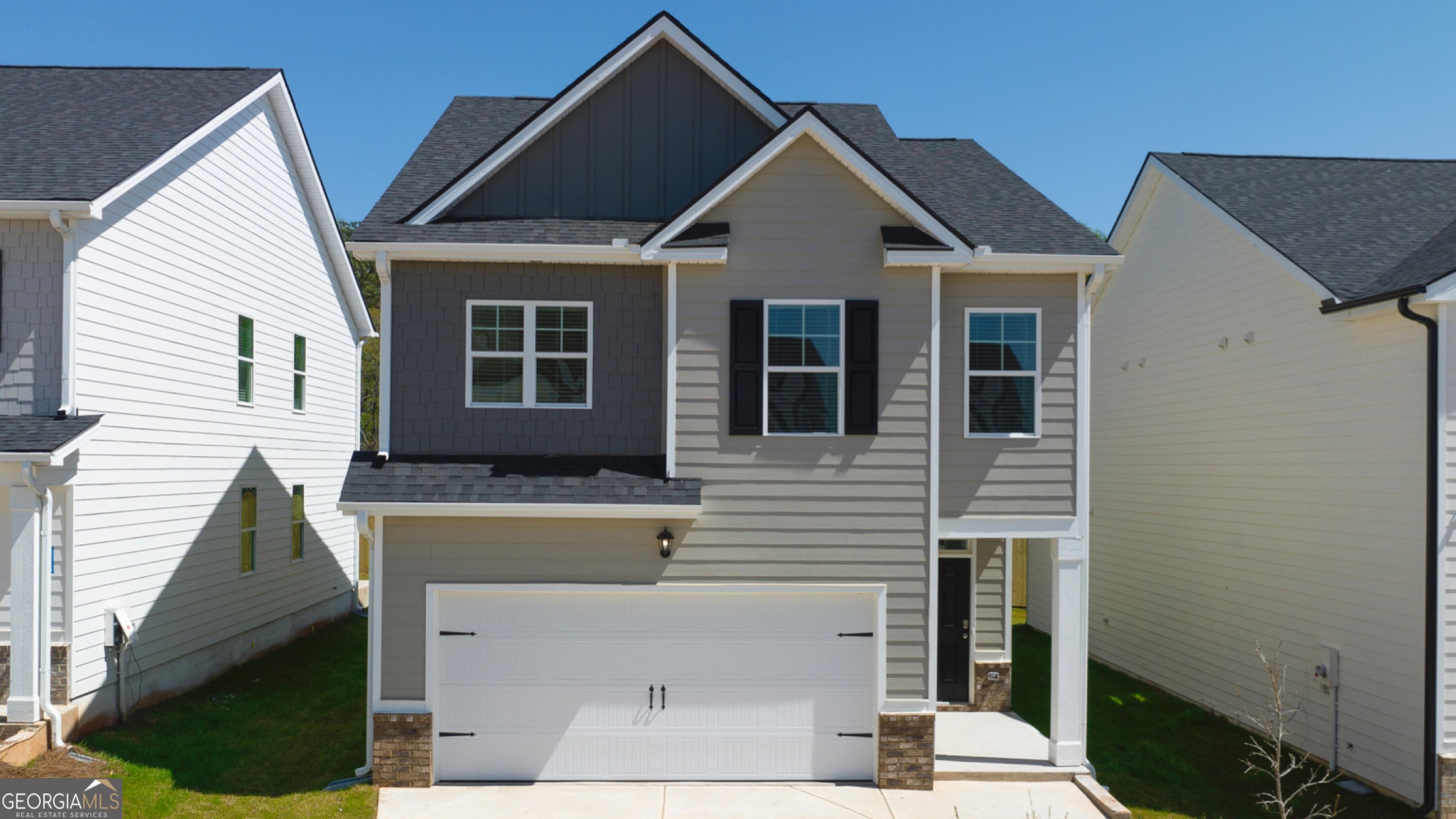 a front view of a house with a yard