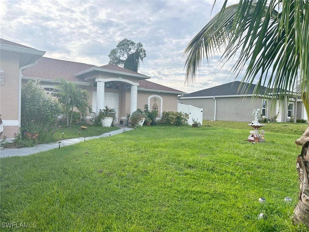 a front view of a house with garden