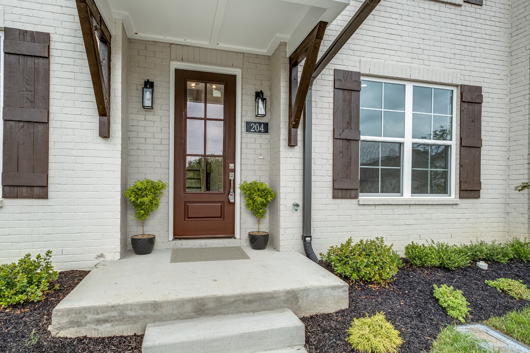 a house with a potted plant in front of door