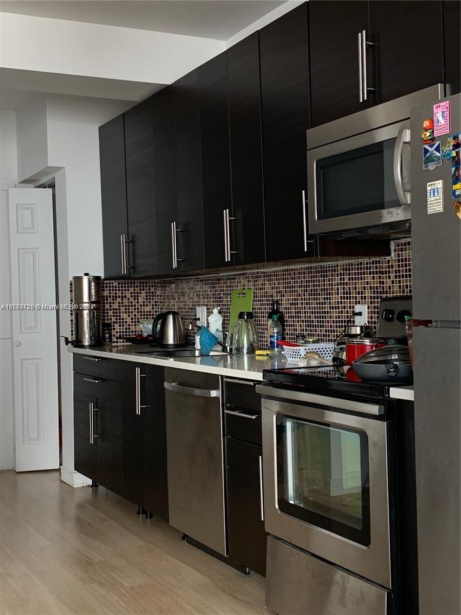 a kitchen with a sink stove and microwave