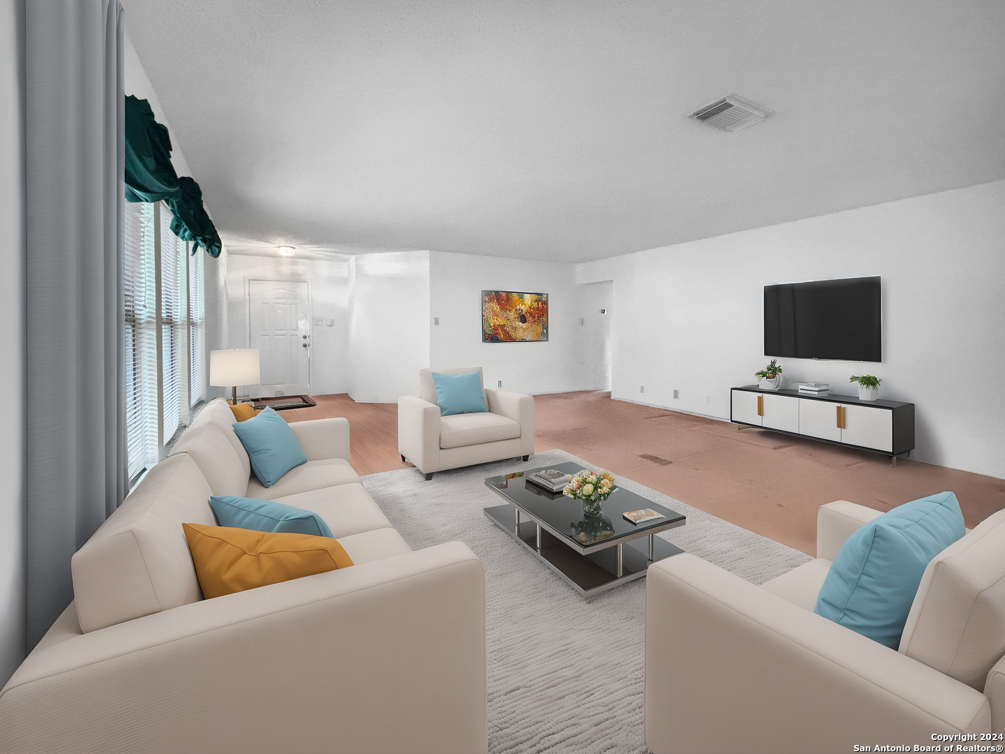 a living room with furniture and a flat screen tv