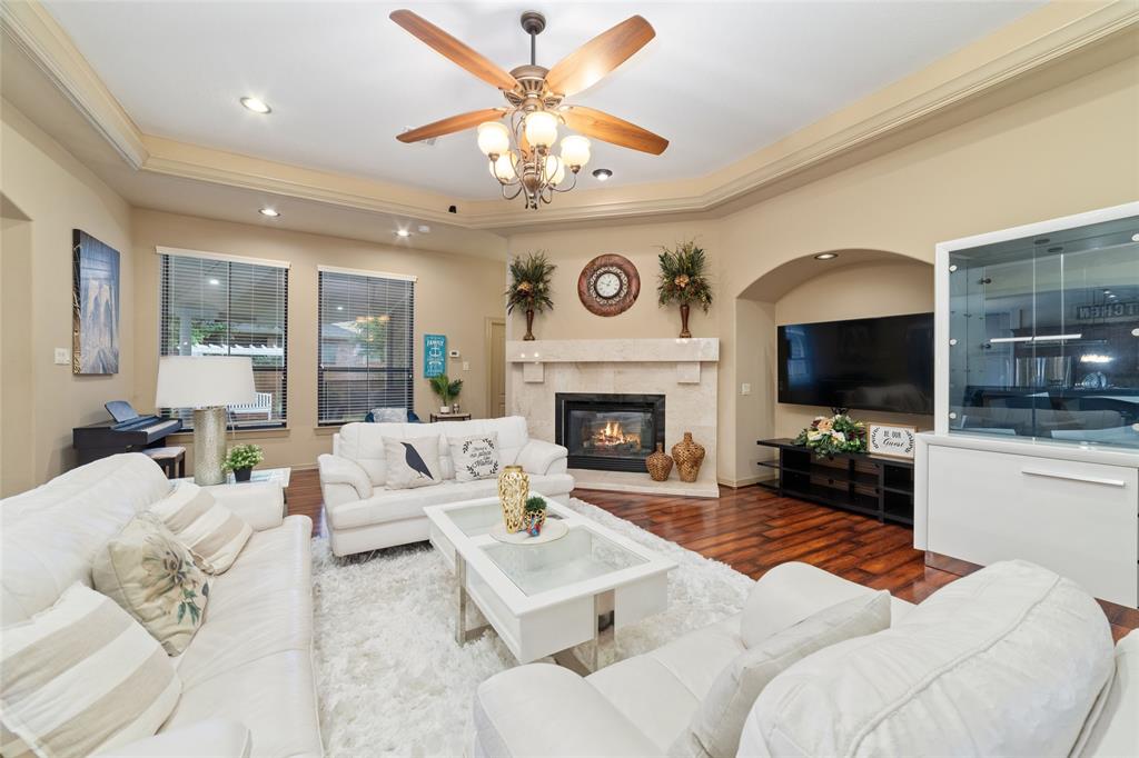 a living room with furniture a flat screen tv and a fireplace