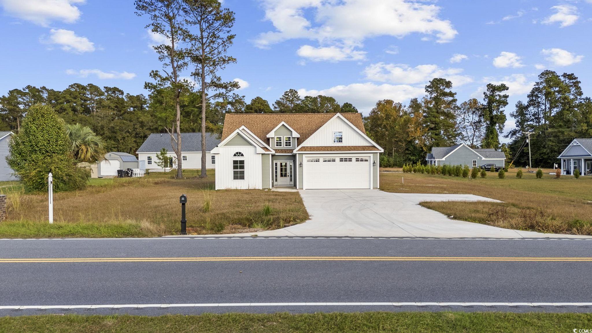 View of front facade featuring a garage and a fron