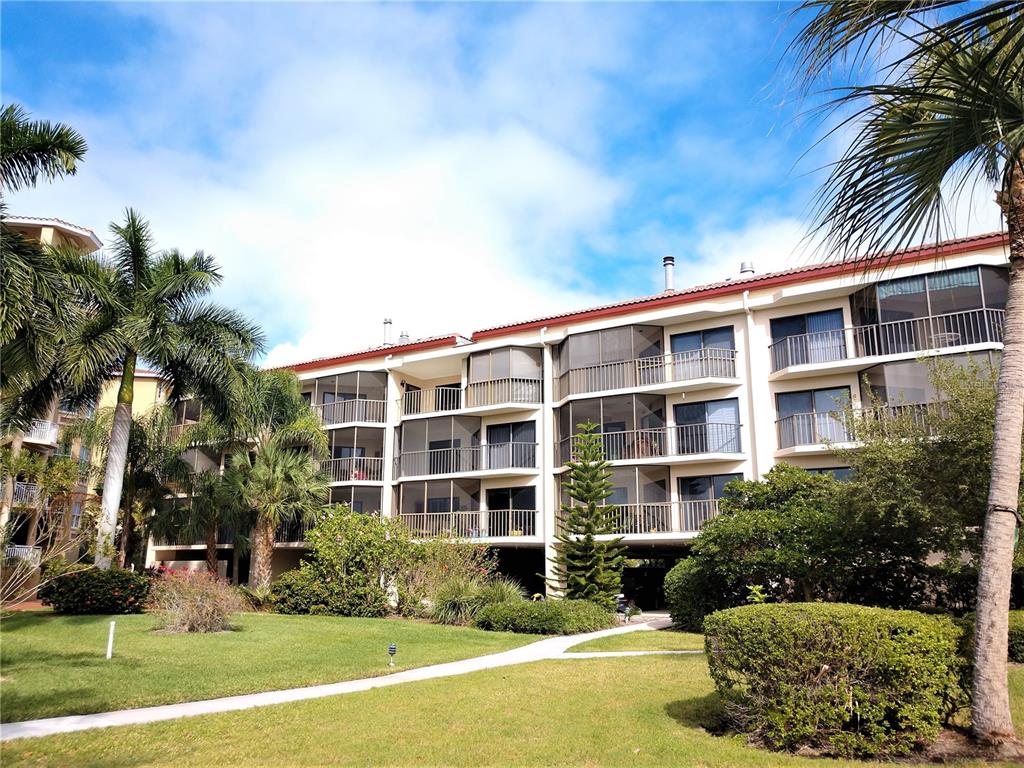 a front view of a building with a garden