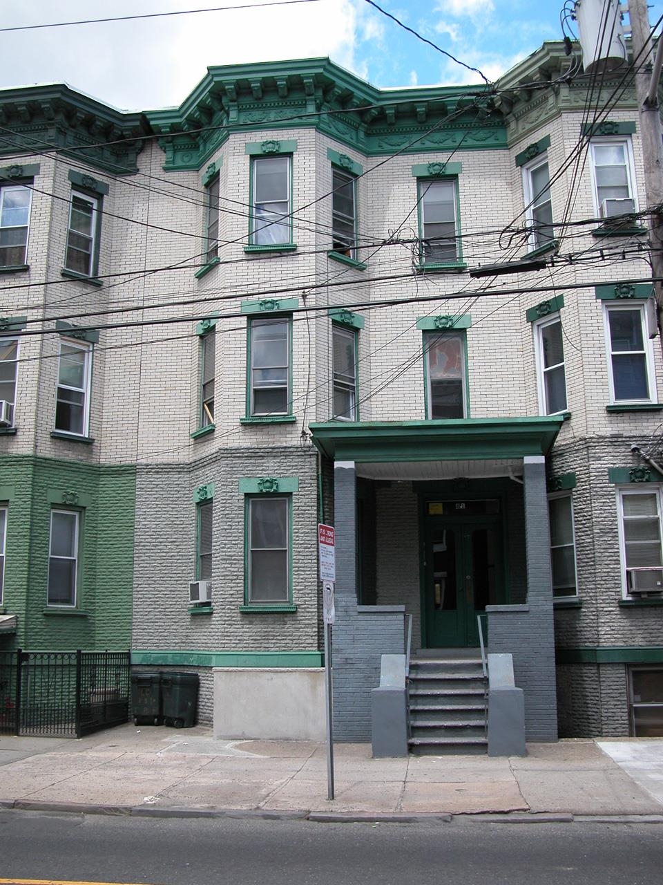 a view of a white building with large windows