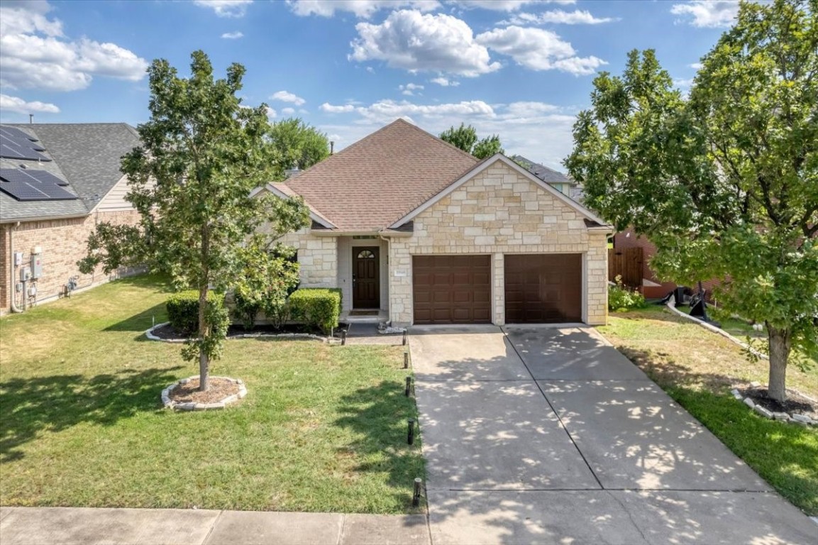 a view of a house with yard and tree s