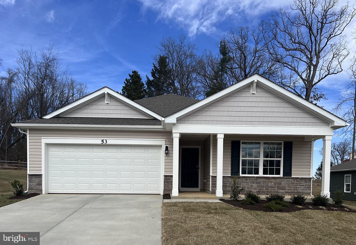 a front view of a house with yard and garage