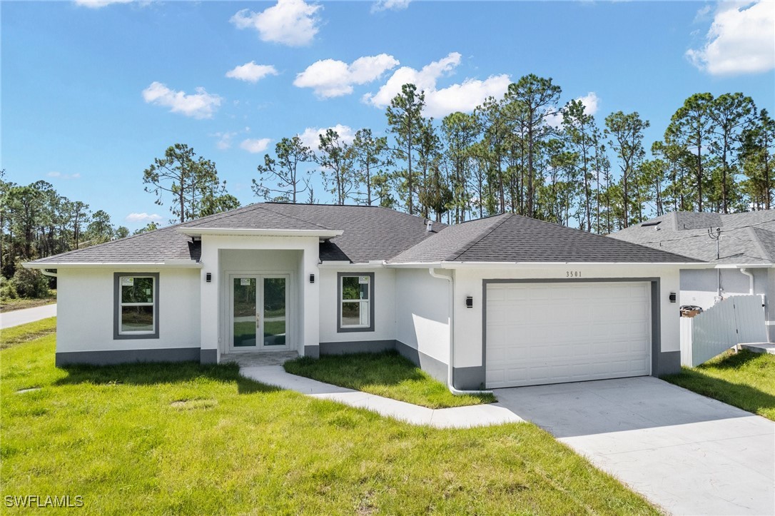 a front view of a house with a yard garage and outdoor seating