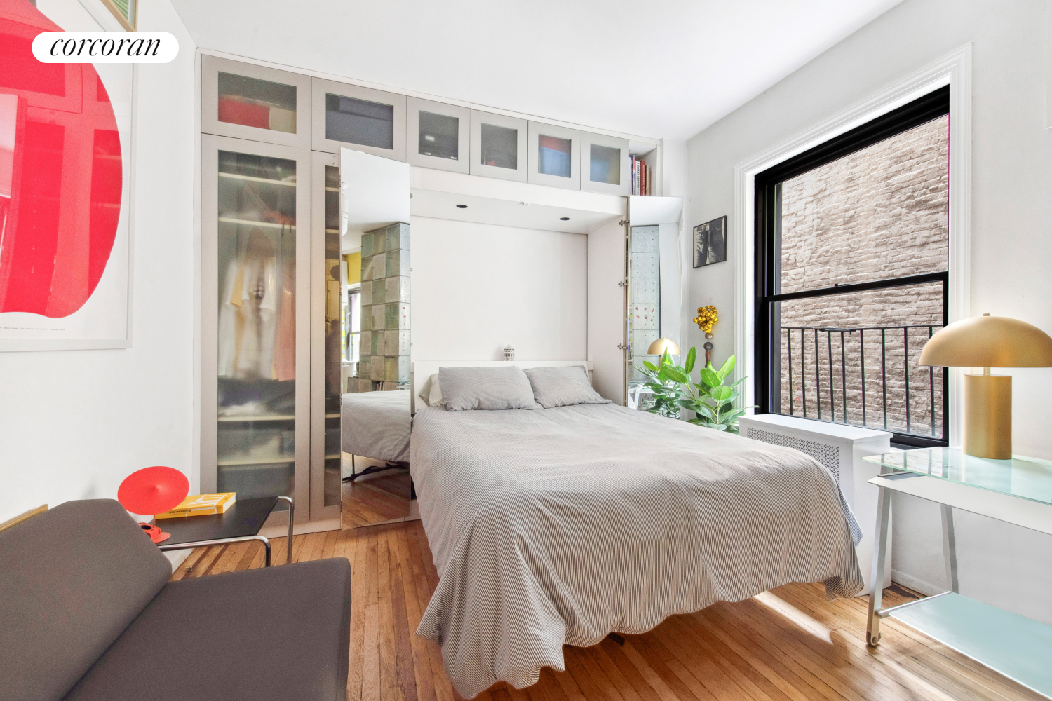 a bedroom with bed and wooden floor