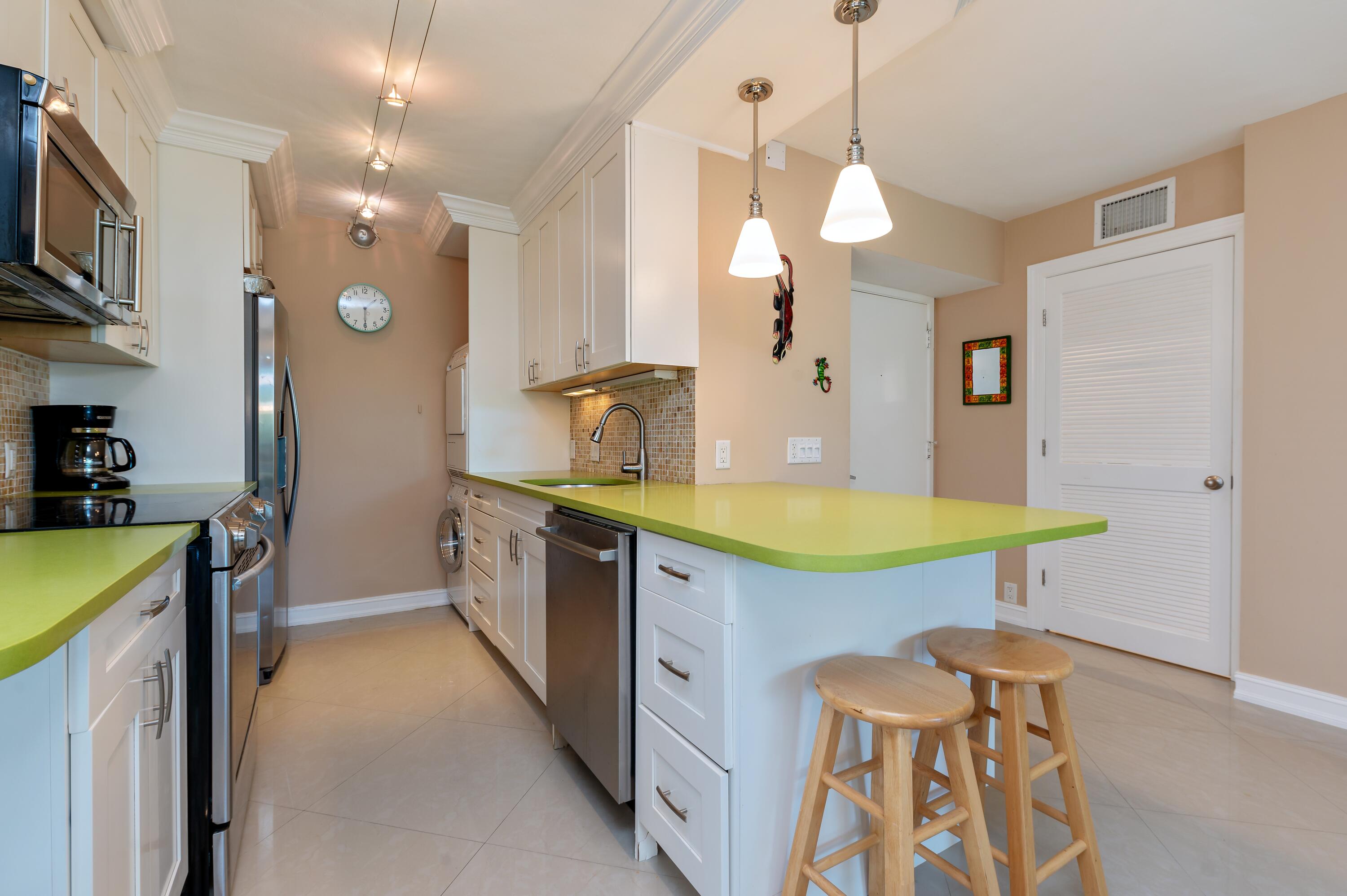 a bathroom with a granite countertop sink a toilet a mirror and bathtub