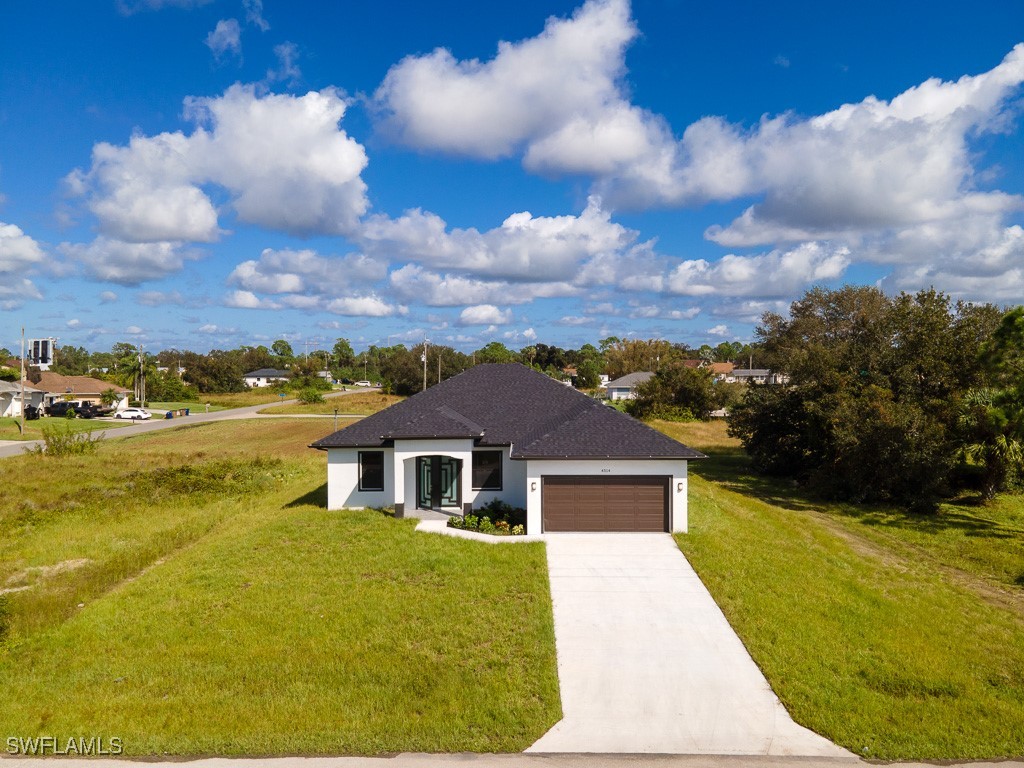 a front view of house with yard and entertaining space