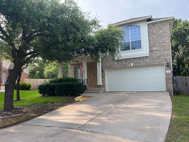 a front view of a house with a yard and a garage